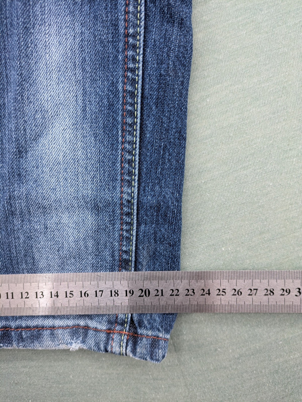 Y2K blue straight jeans with colorful logo embroidery and baggy fit.