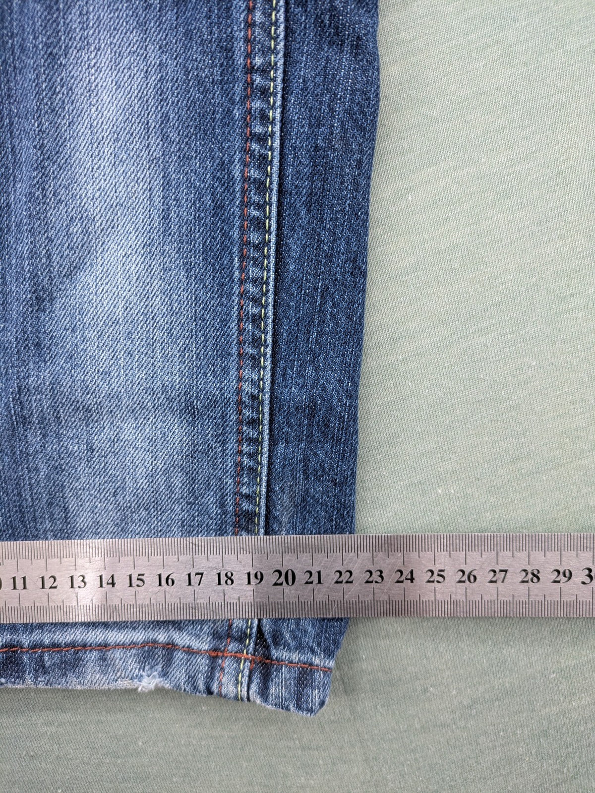 Y2K blue straight jeans with colorful logo embroidery and baggy fit.