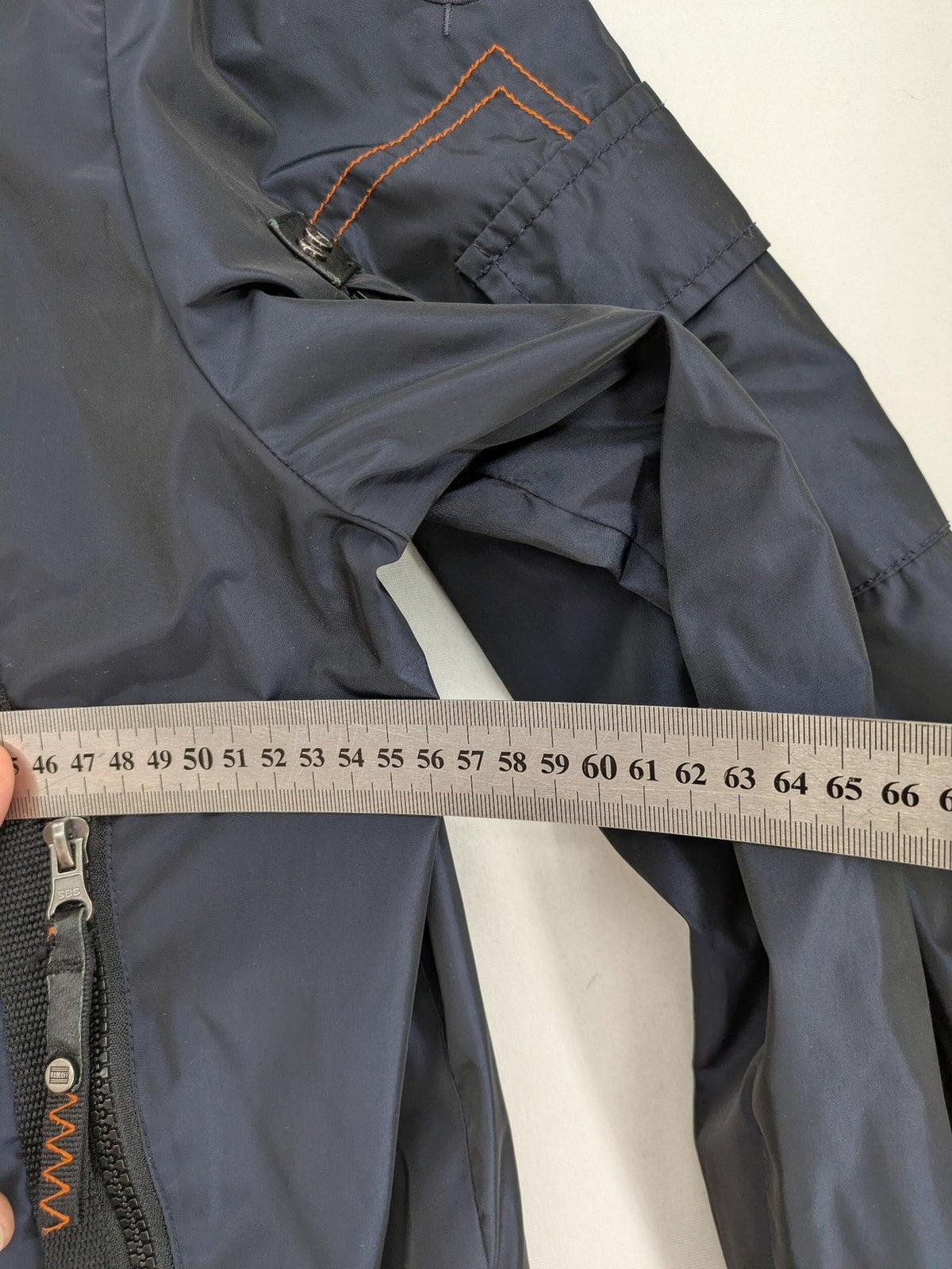Radloff grey navy bomber jacket with orange contrast stitching and zippered pockets.