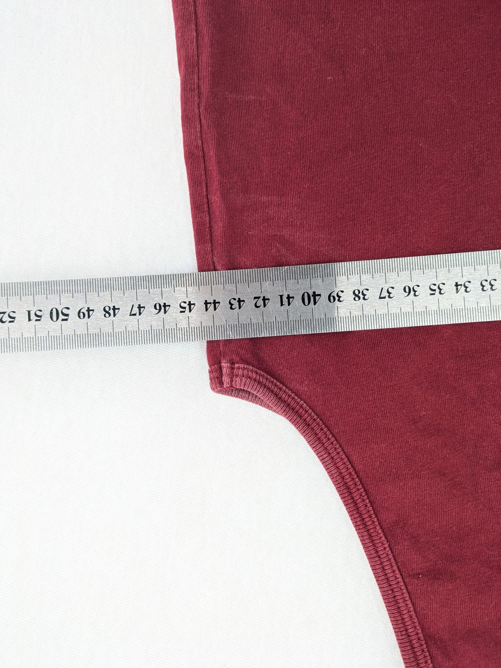 Carhartt burgundy tank top 100% cotton with iconic logo patch at hem.