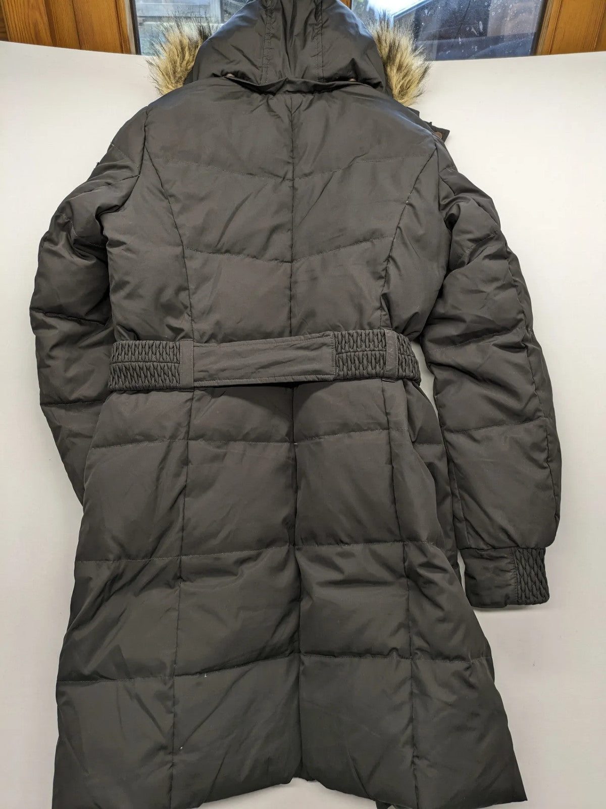Esprit black quilted coat with removable faux fur hood and elastic waist belt.