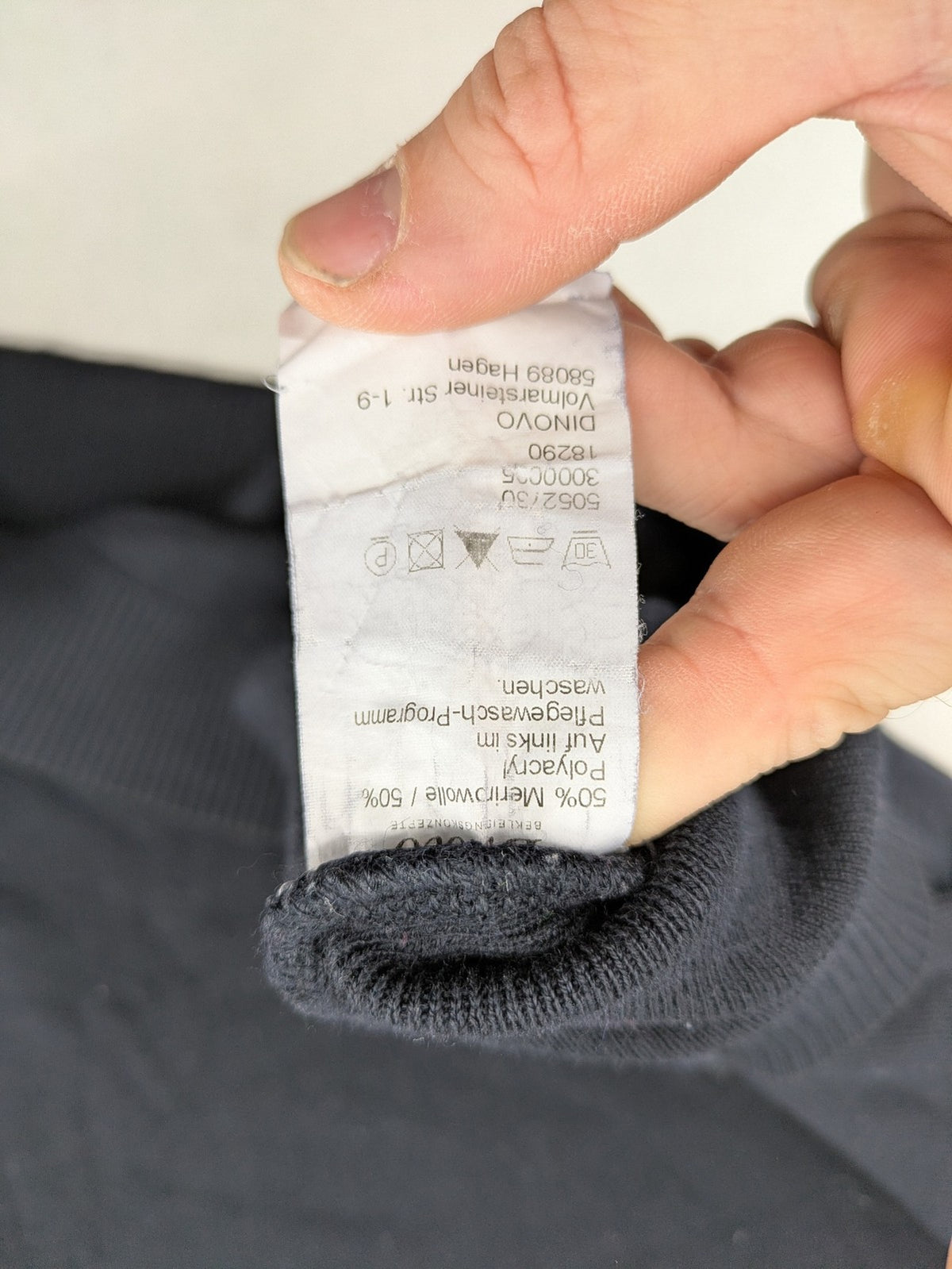 Dinovo grey knit jumper with ribbed roll neck and cuffs, made from merino wool blend.