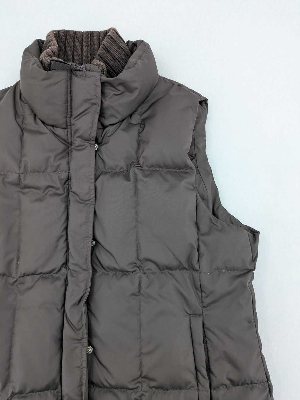 Esprit brown puffer vest with high ribbed collar and zip button closure.