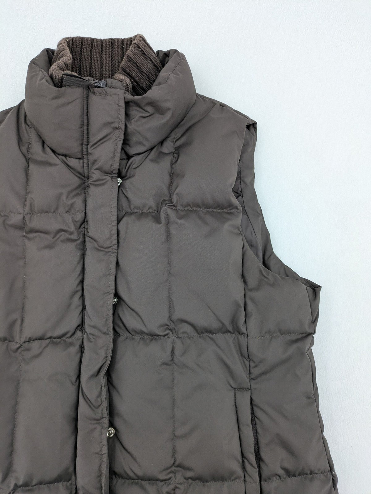 Esprit brown puffer vest with high ribbed collar and zip button closure.
