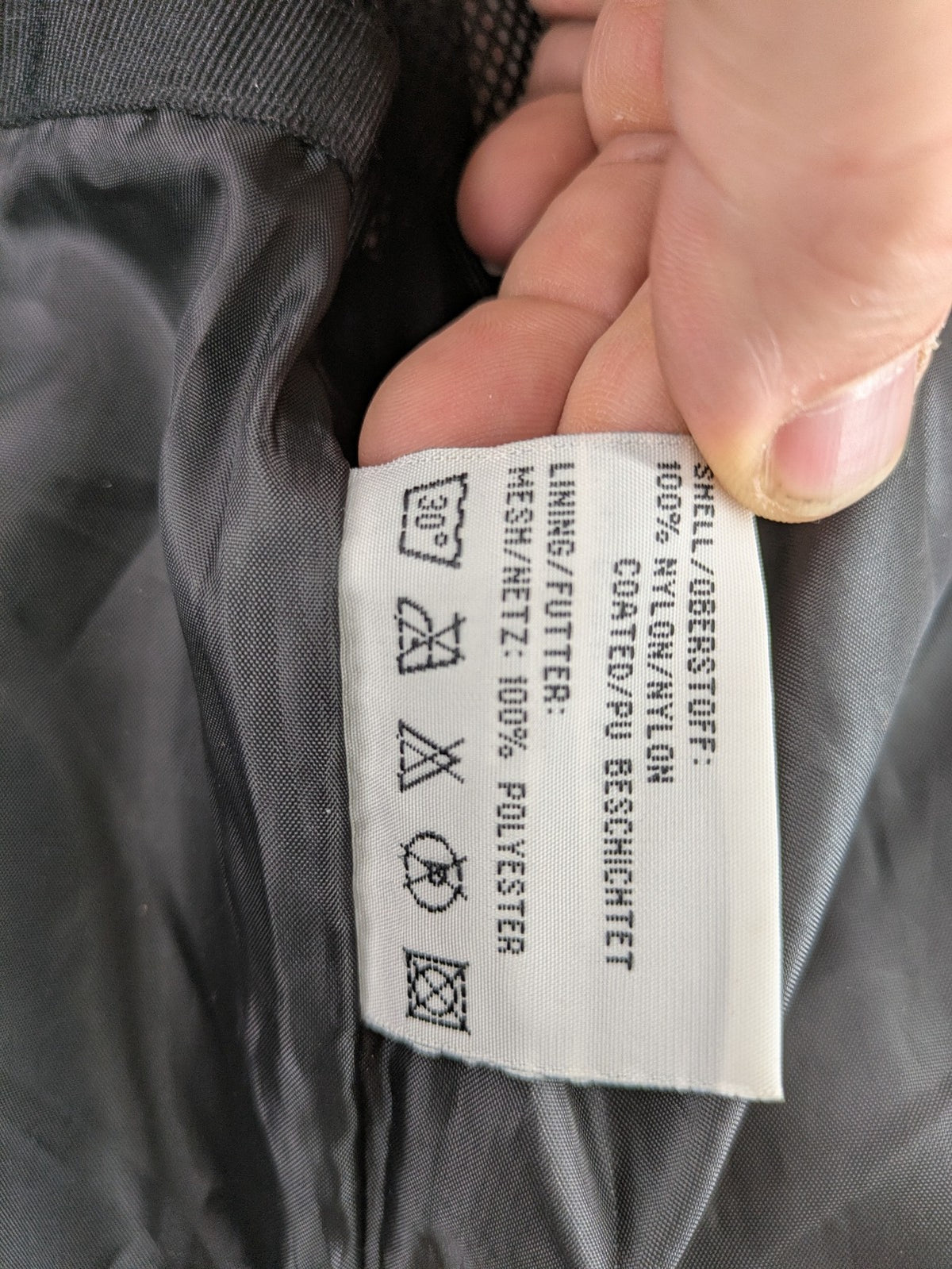 Black Bear black rain jacket with coral pink mesh lining and full zipper.