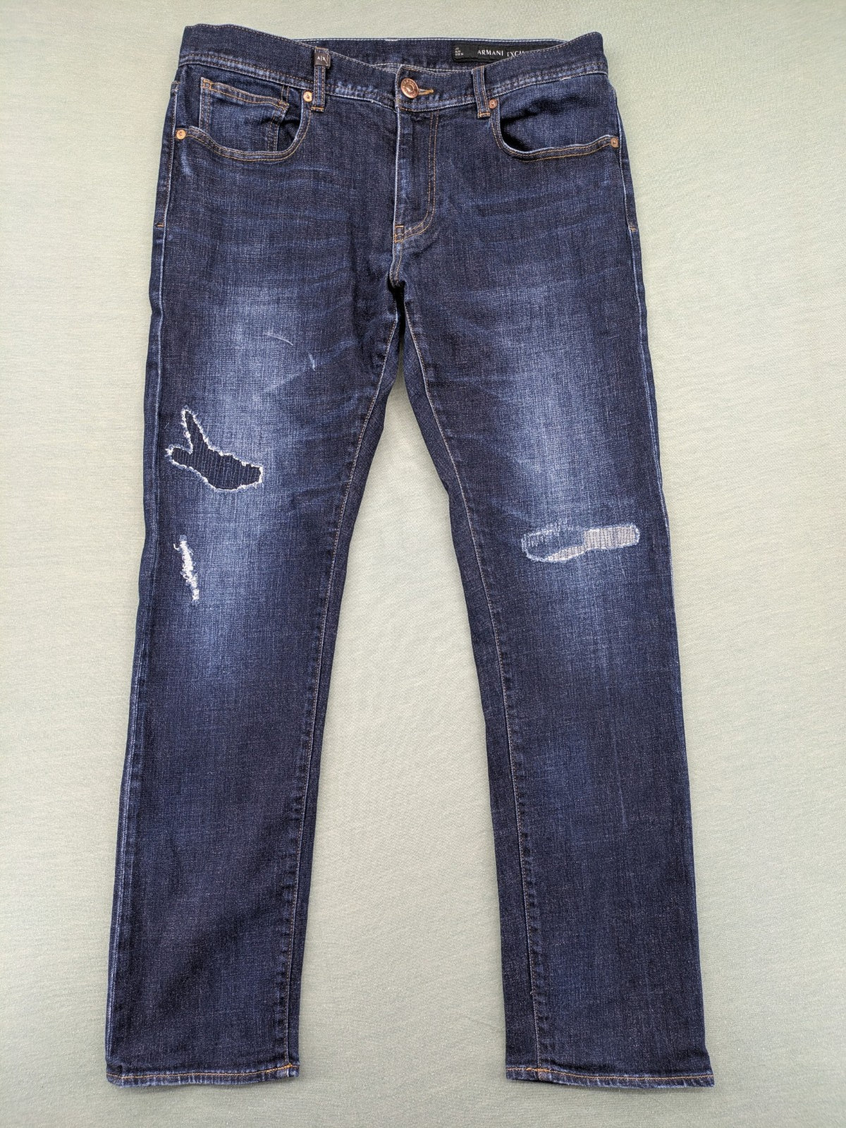 Armani Exchange blue slim fit jeans with distressed details and classic 5-pocket design.