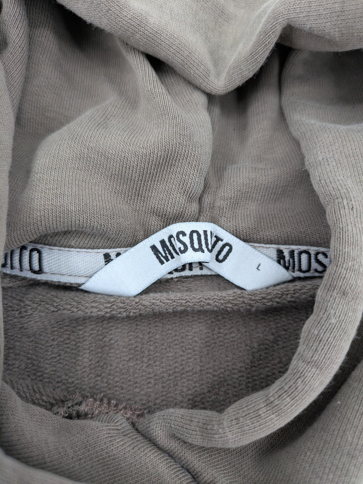 Mosquito grey hoodie with distressed cuffs and subtle logo on the chest.