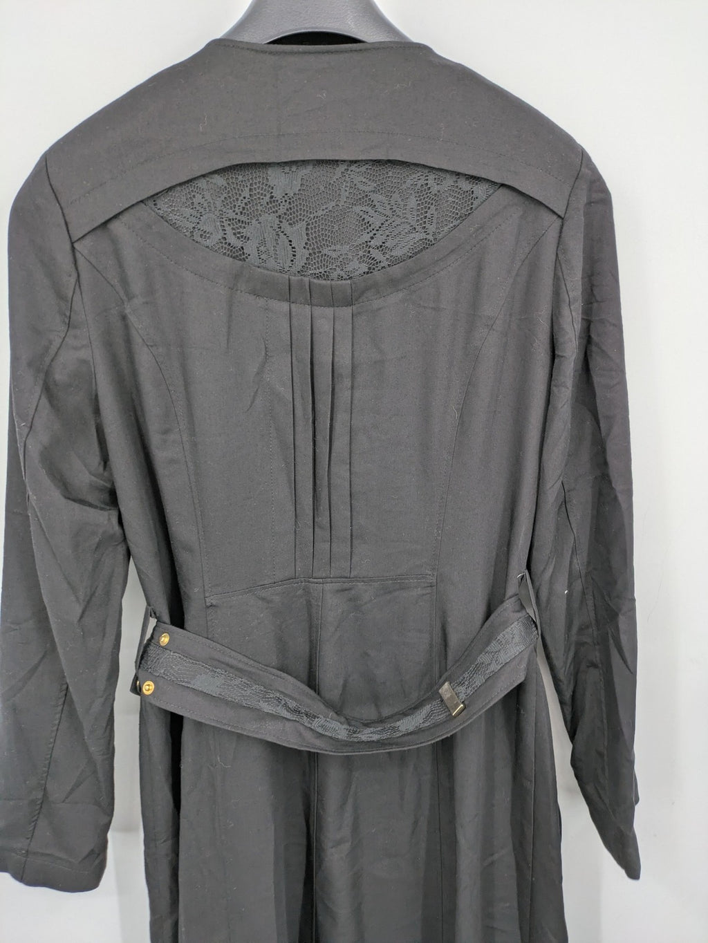 Alvina black trench coat with lace collar and gold buttons, belted waist design.