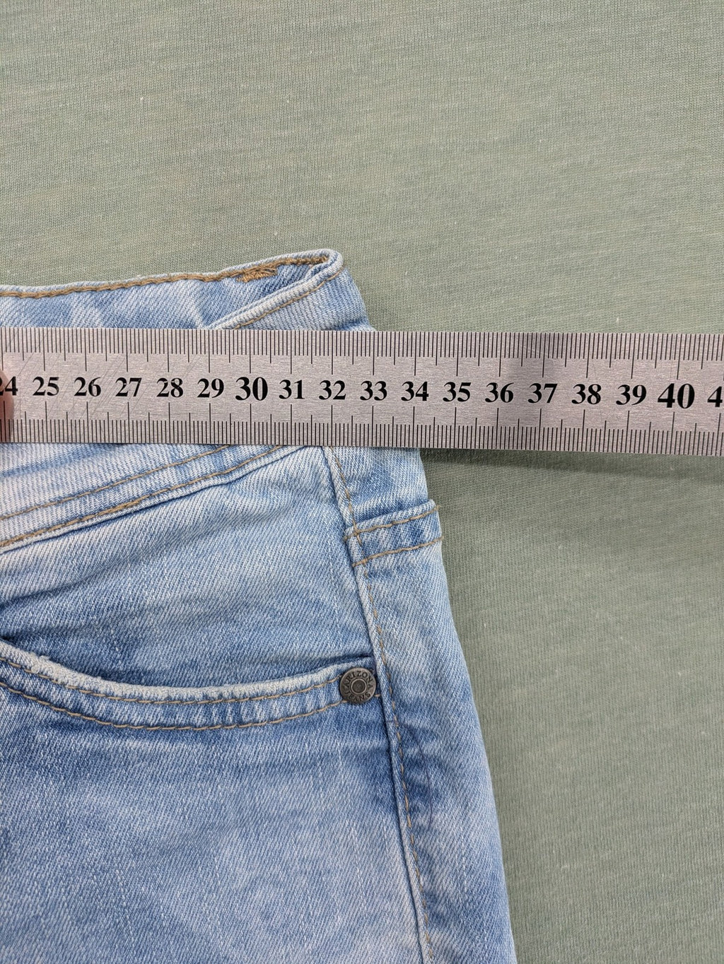 Arizona blue flare jeans with acid wash, button fly, and stretch denim material.
