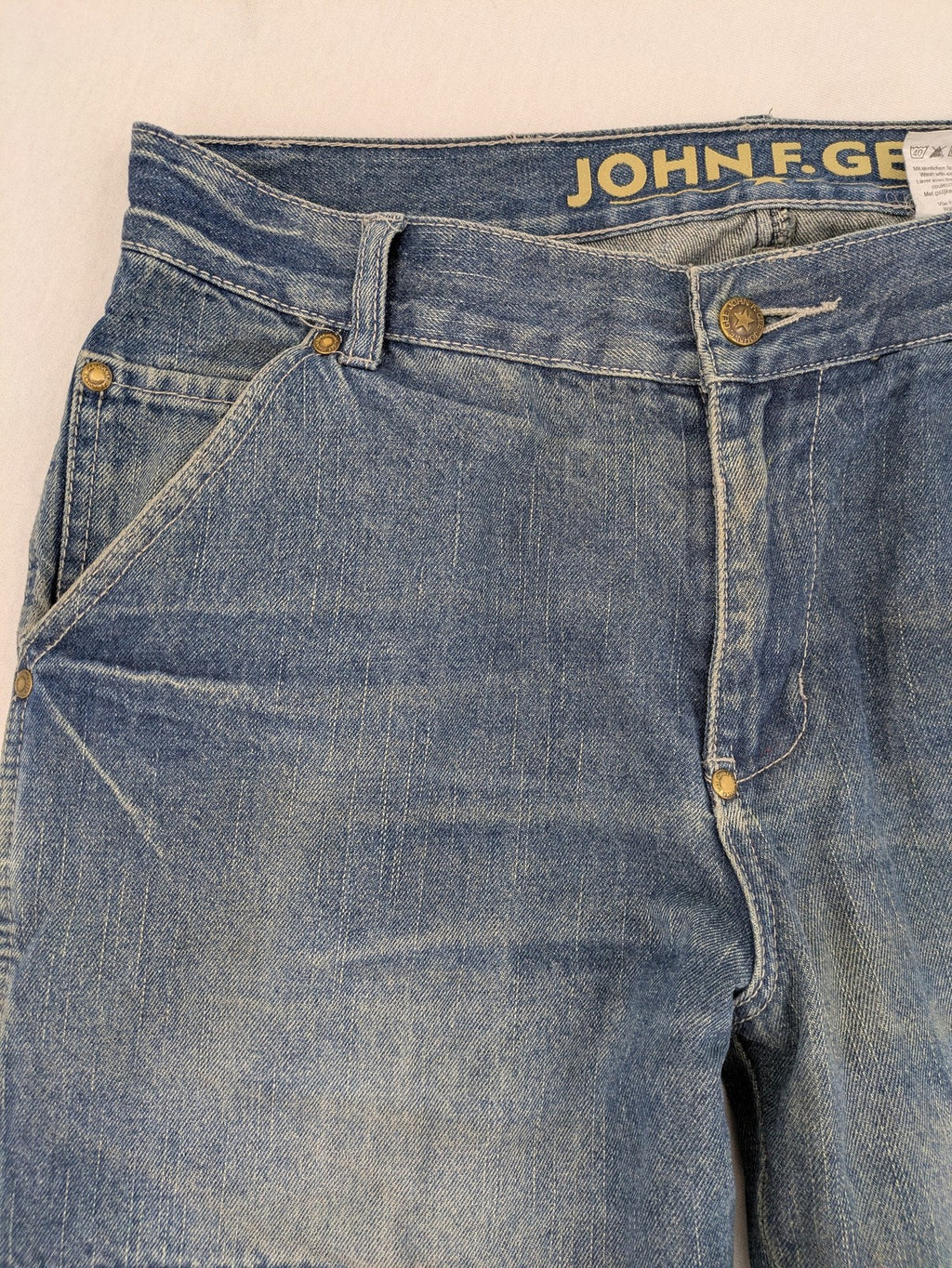 John F. Gee blue straight jeans with reinforced knees and durable denim material.