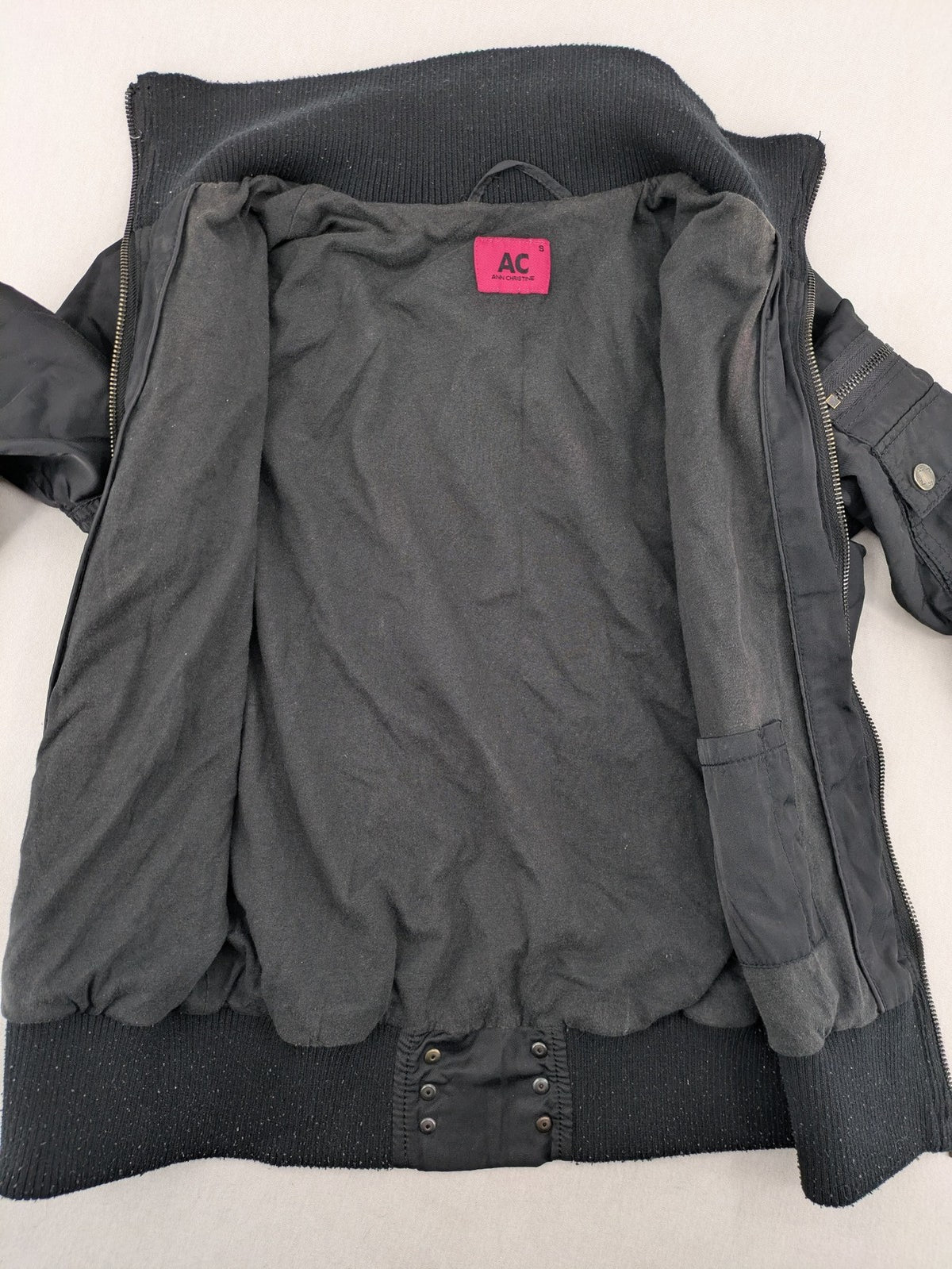Ann Christine black bomber jacket with striped ribbed collar and cuffs, zip closure.
