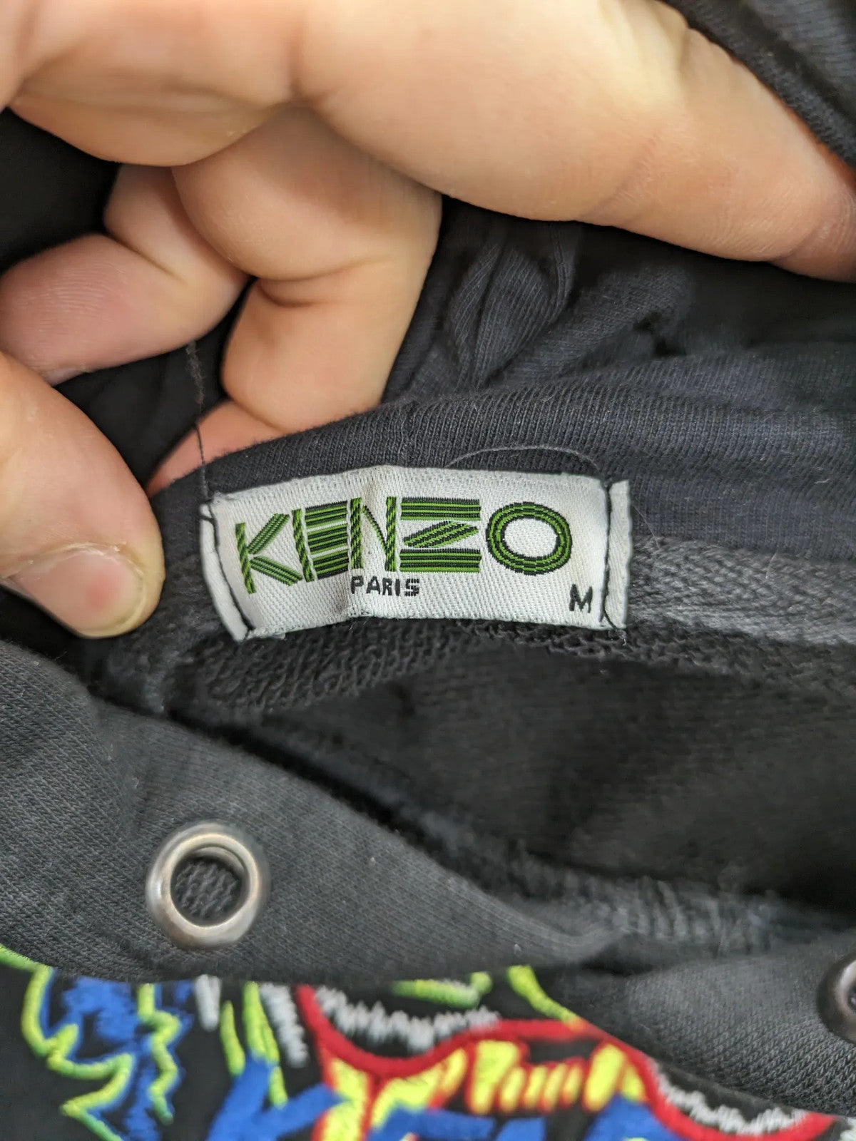 Kenzo multi hoodie with embroidered tiger graphic, drawstring hood, and kangaroo pocket.