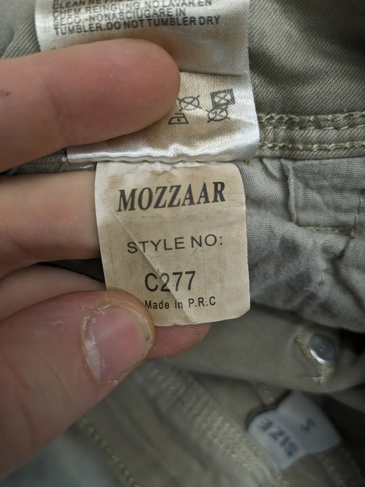 Mozaar beige straight jeans with unique asymmetrical button placket and practical pockets.