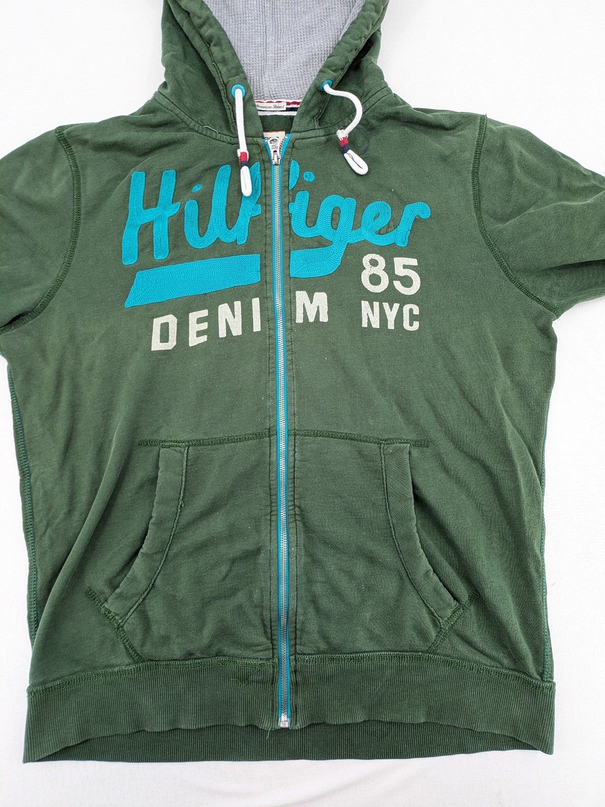 Tommy Hilfiger Denim green hoodie full zip with large graphic logo and grey waffle lining.