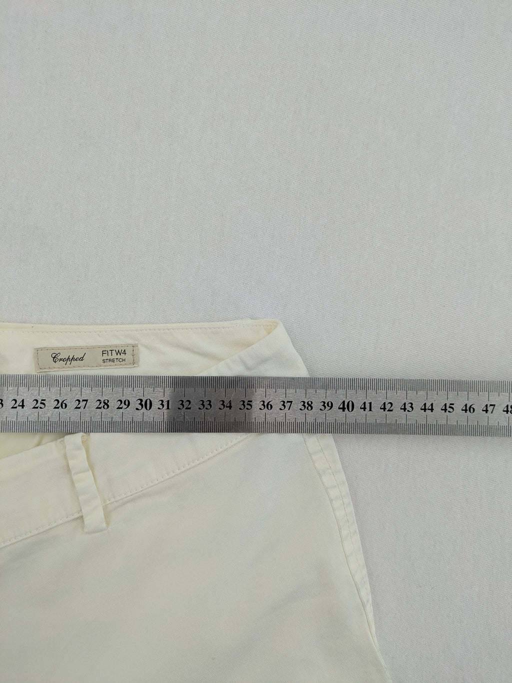 MaxMara cream cropped chino pants with zipper closure, belt loops, and back pockets.