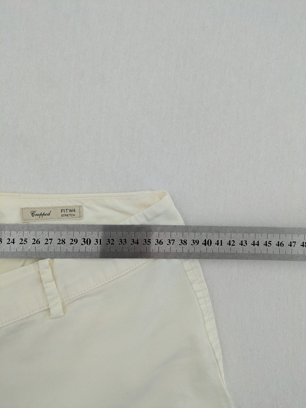 MaxMara cream cropped chino pants with zipper closure, belt loops, and back pockets.