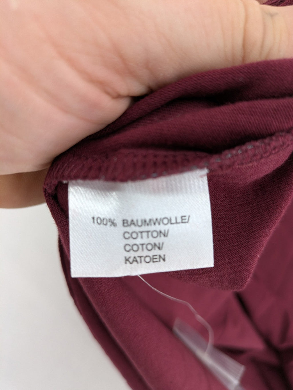 Jan Vanderstorm burgundy Henley shirt with button placket and "087 JV DEPT" graphic print.