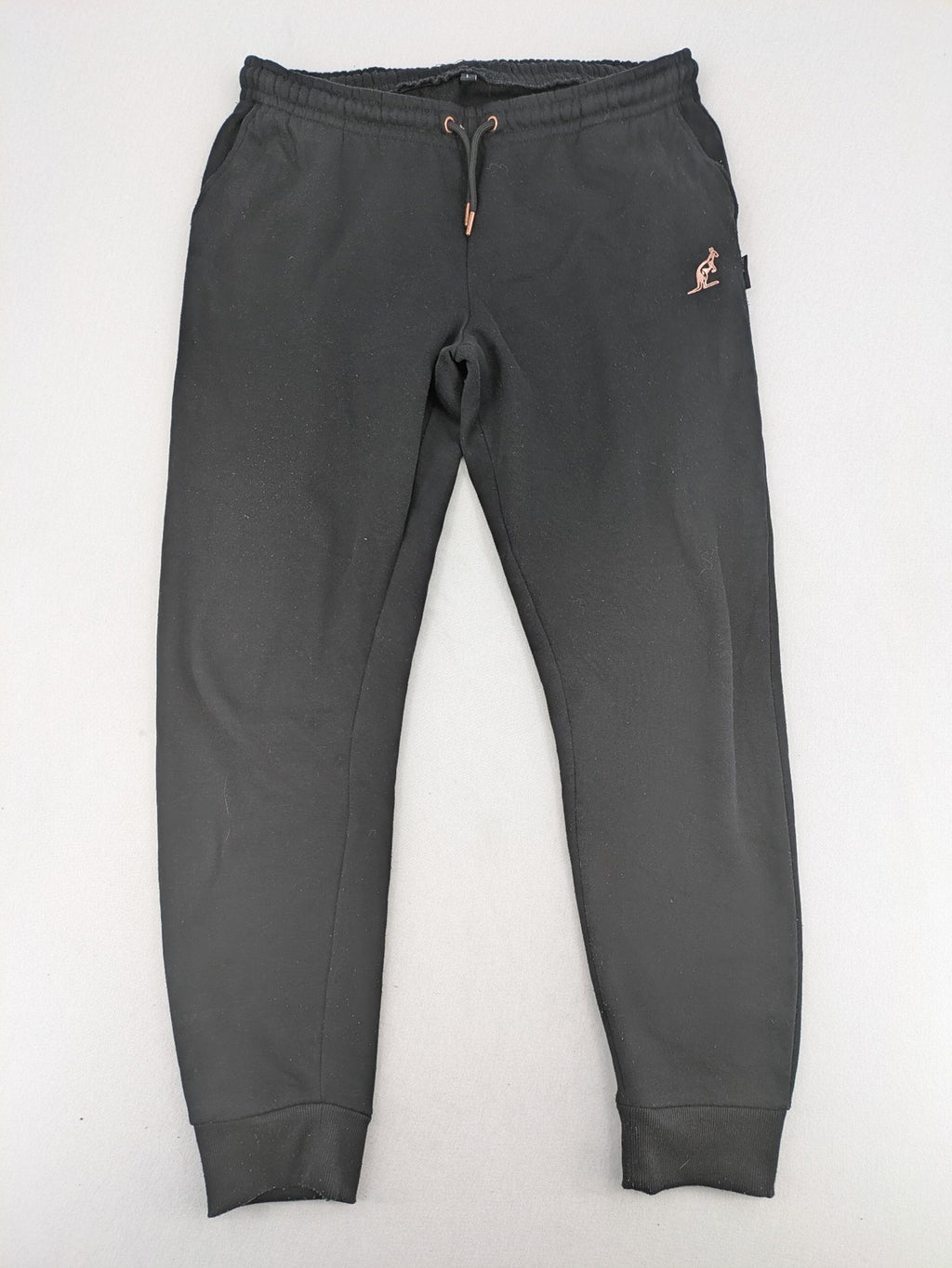 Kuyruun black jogging pants with kangaroo logo, elastic waistband, and ribbed cuffs.