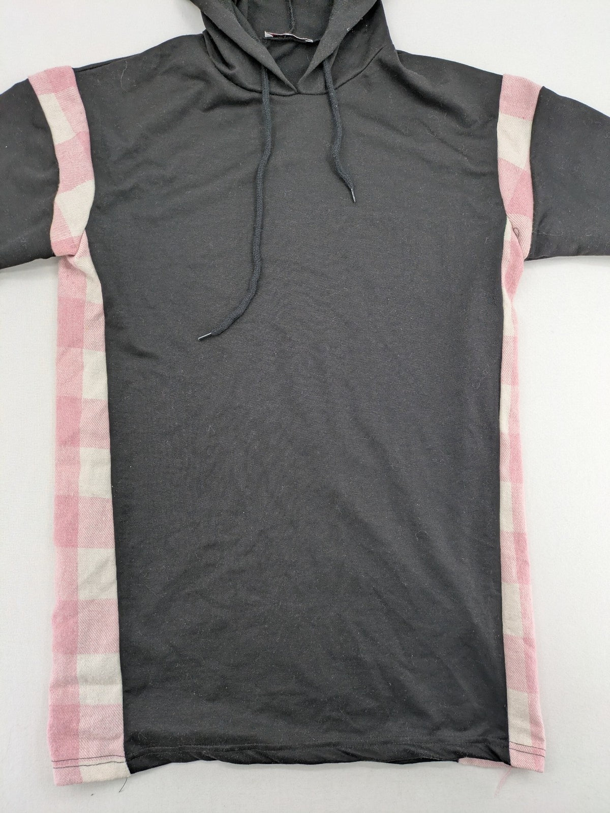 L'ange pink hoodie dress with black body and contrasting pink-white checkered panels.