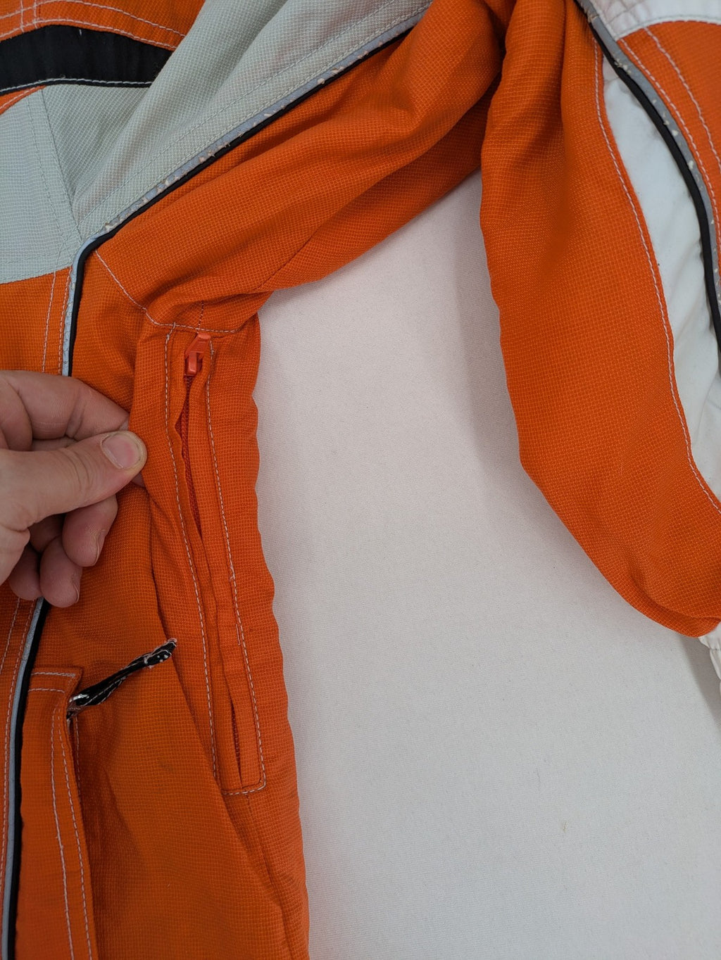 Outback orange outdoor jacket size 42 with reflective accents and mixed color details.