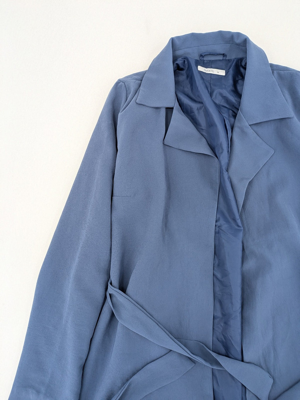 DeFacto blue trench coat with classic lapels and matching self-tie belt.
