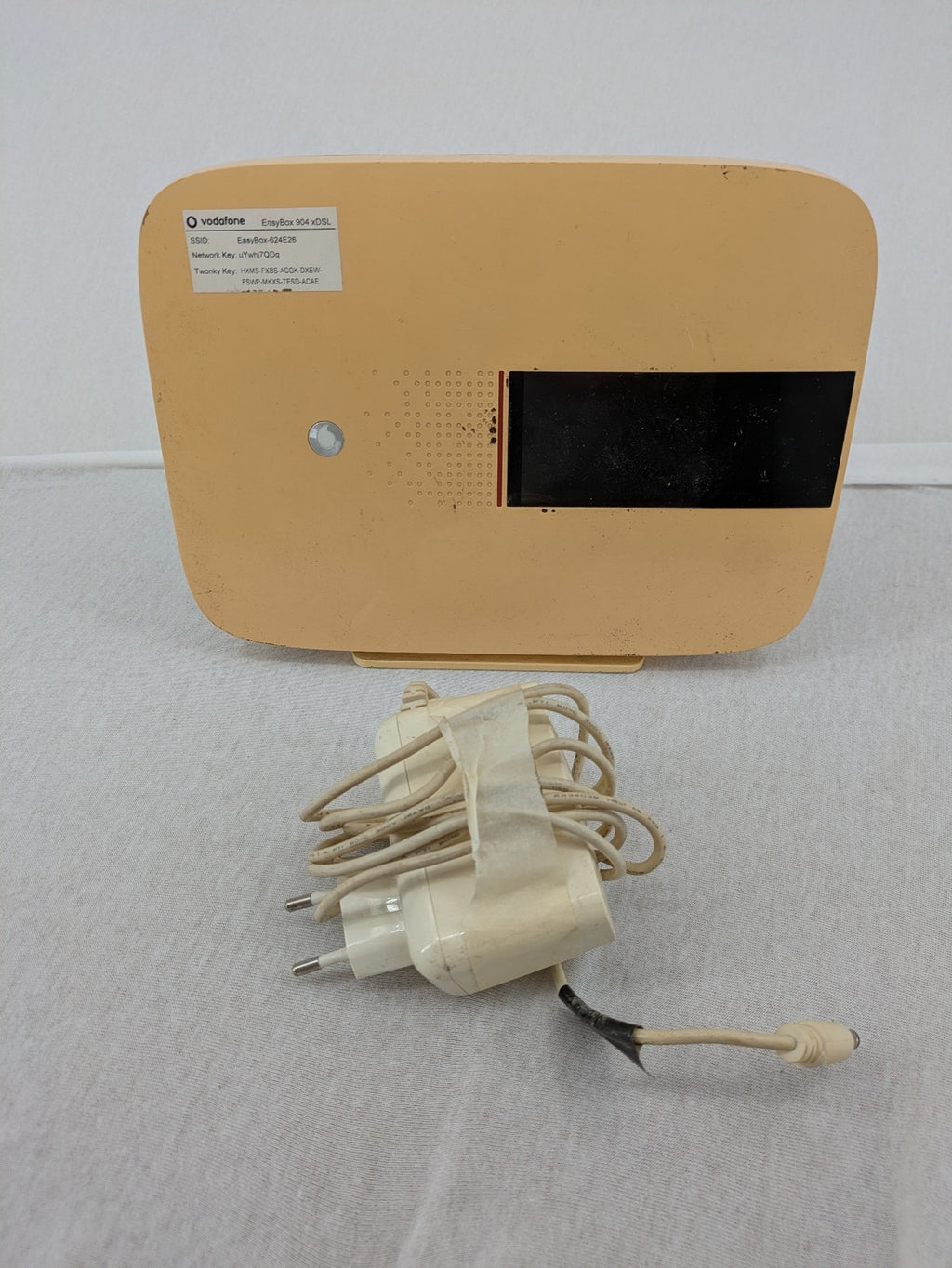 Vodafone beige wireless router with multiple LAN ports and DSL connectivity.