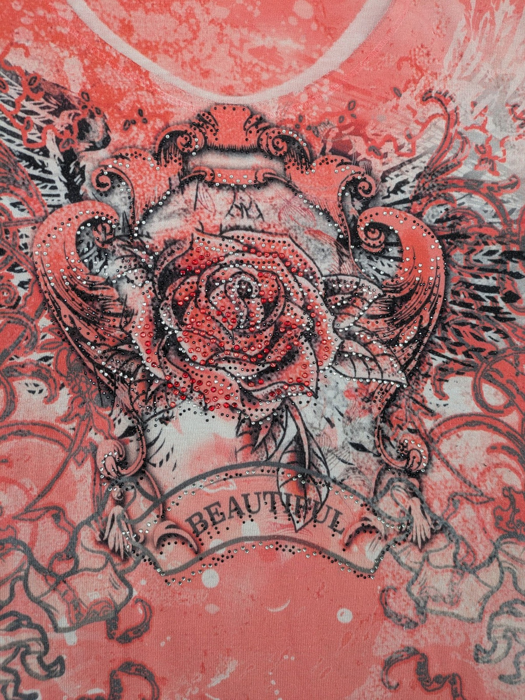TREDY pink graphic top with rose and wings design, embellished with rhinestones.