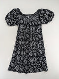 Clockhouse black and white floral mini dress with smocked bodice and puff sleeves.