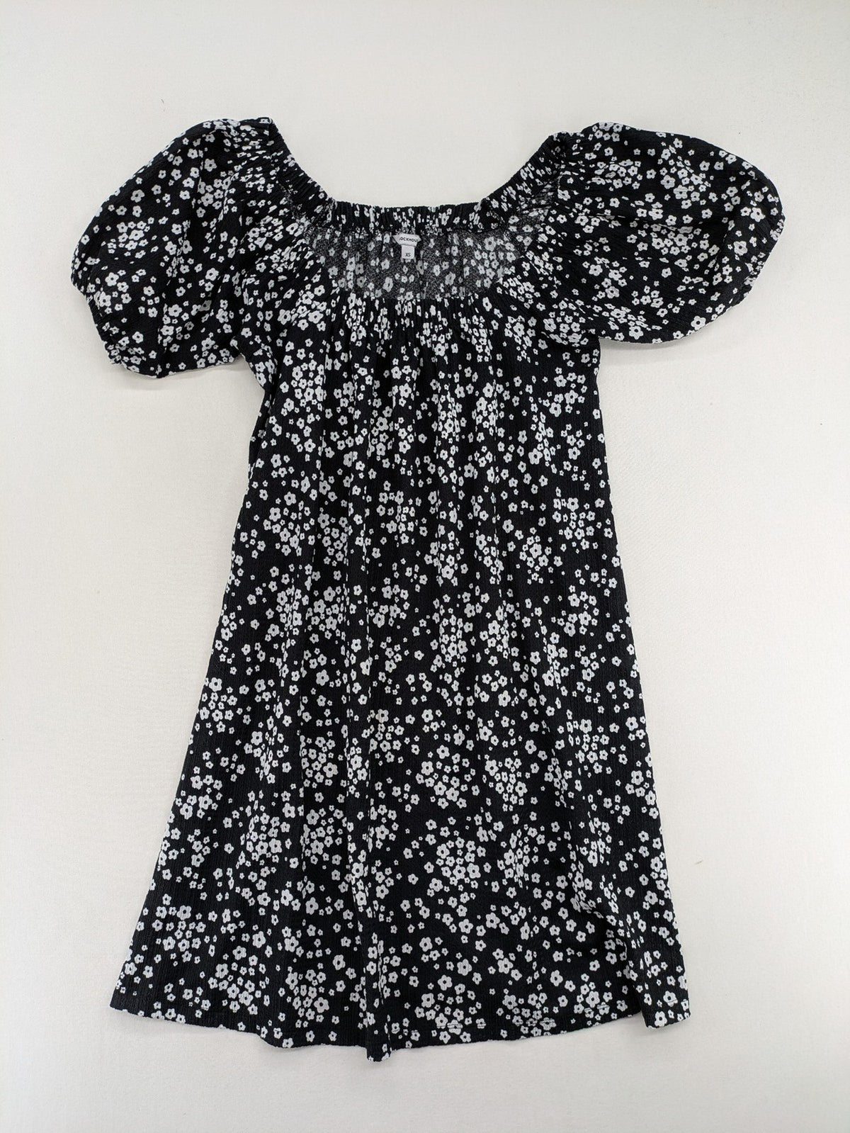 Clockhouse black and white floral mini dress with smocked bodice and puff sleeves.