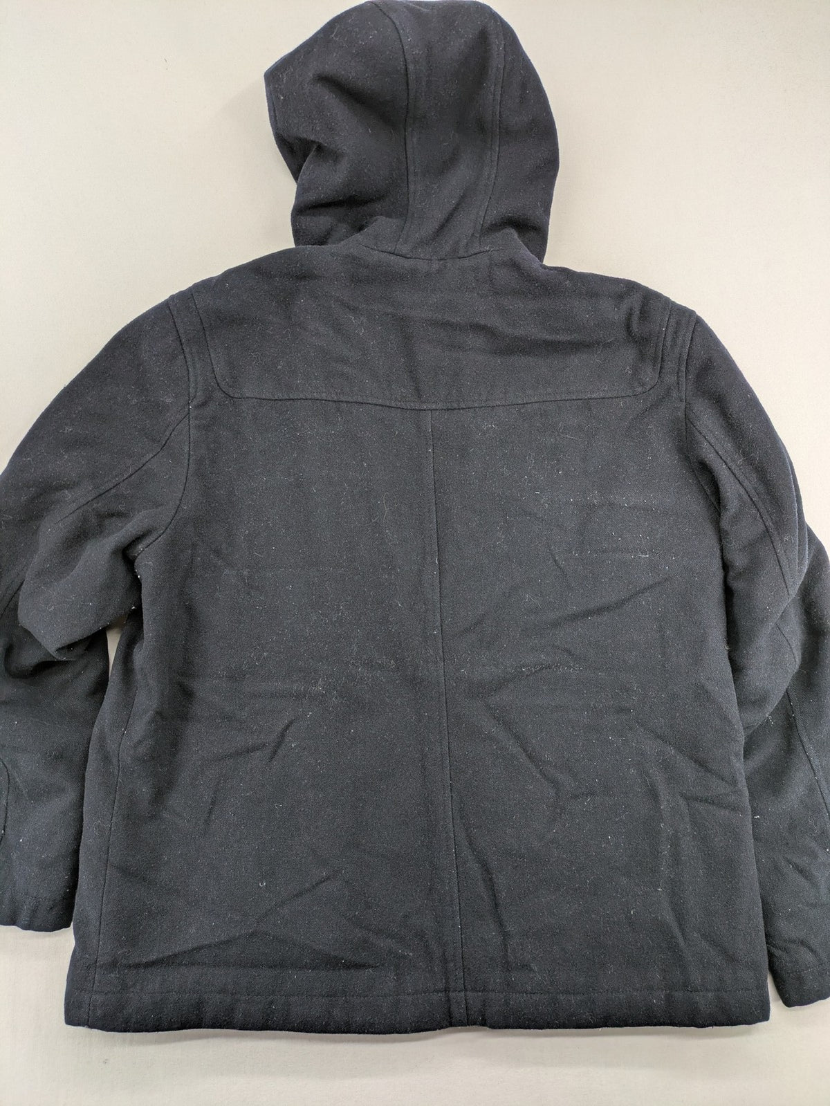 Angelo Litrico black duffle coat with toggle closure and cream Sherpa-lined hood.