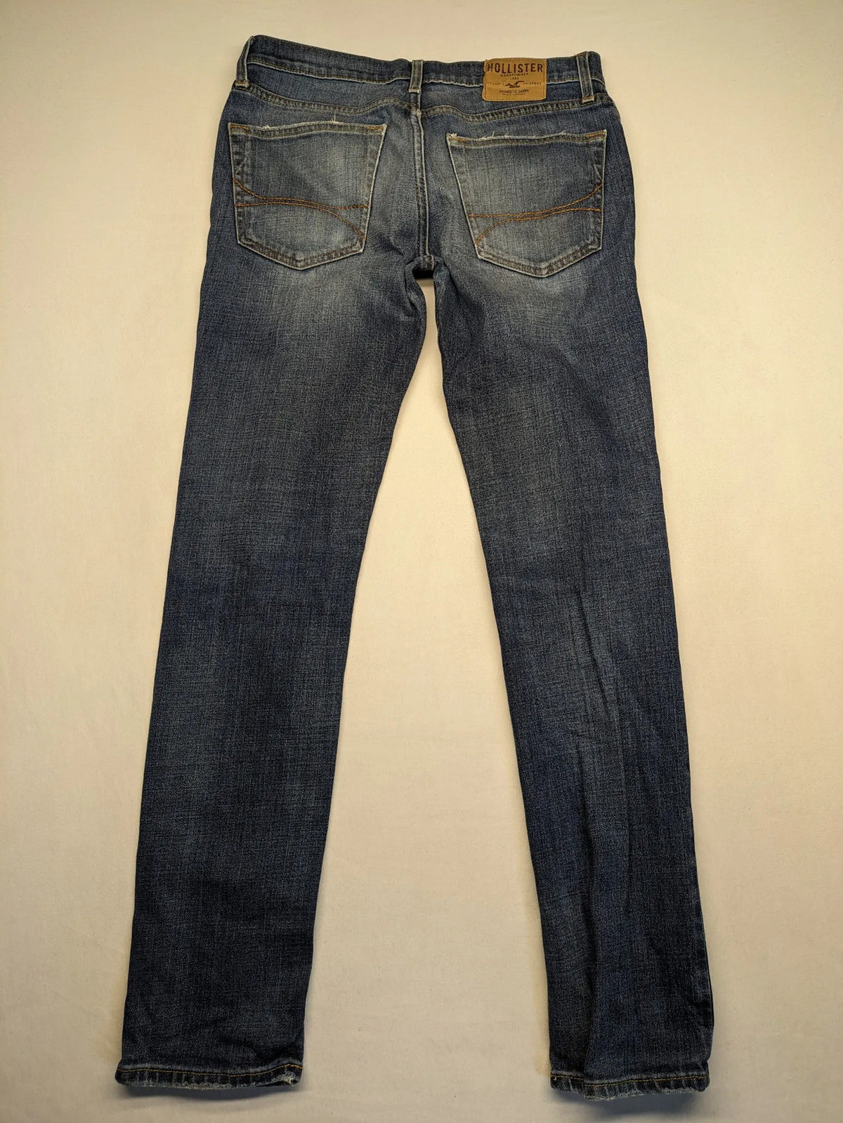 Hollister blue slim fit jeans with distressed detailing and classic button fly.
