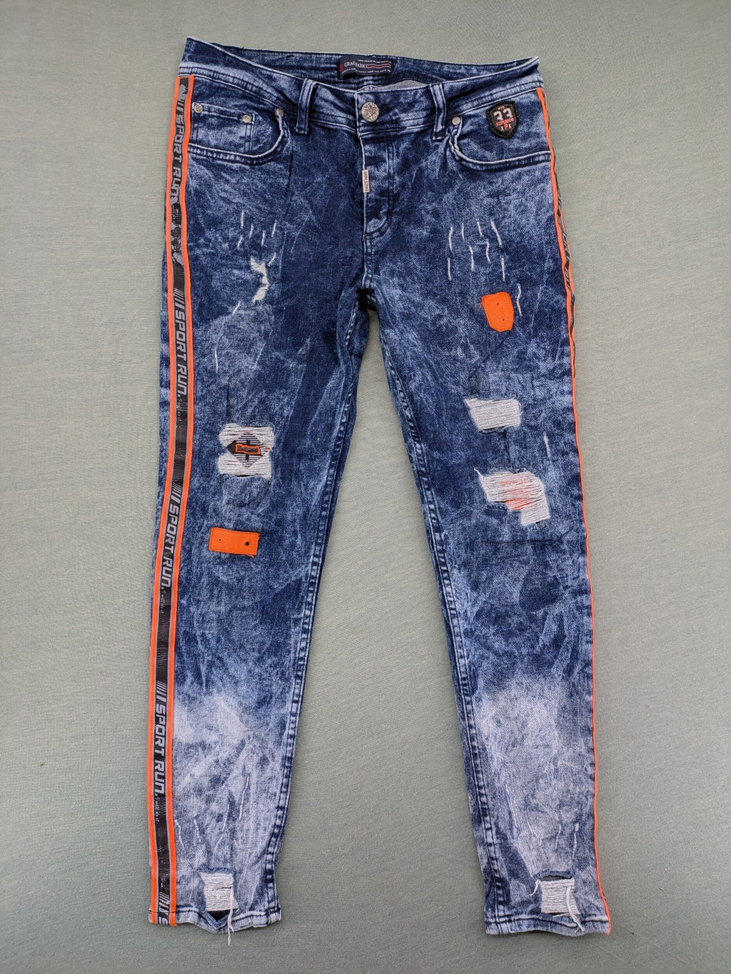 Stark straight jeans multi distressed acid wash with orange patches and side stripes.
