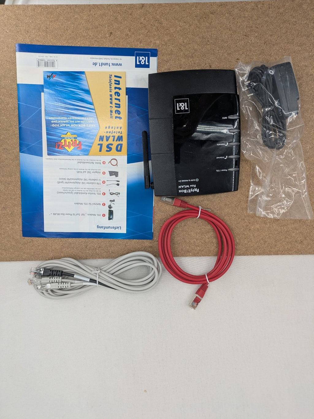 AVM VoIP gateway router blue with integrated DSL modem and phone system features.