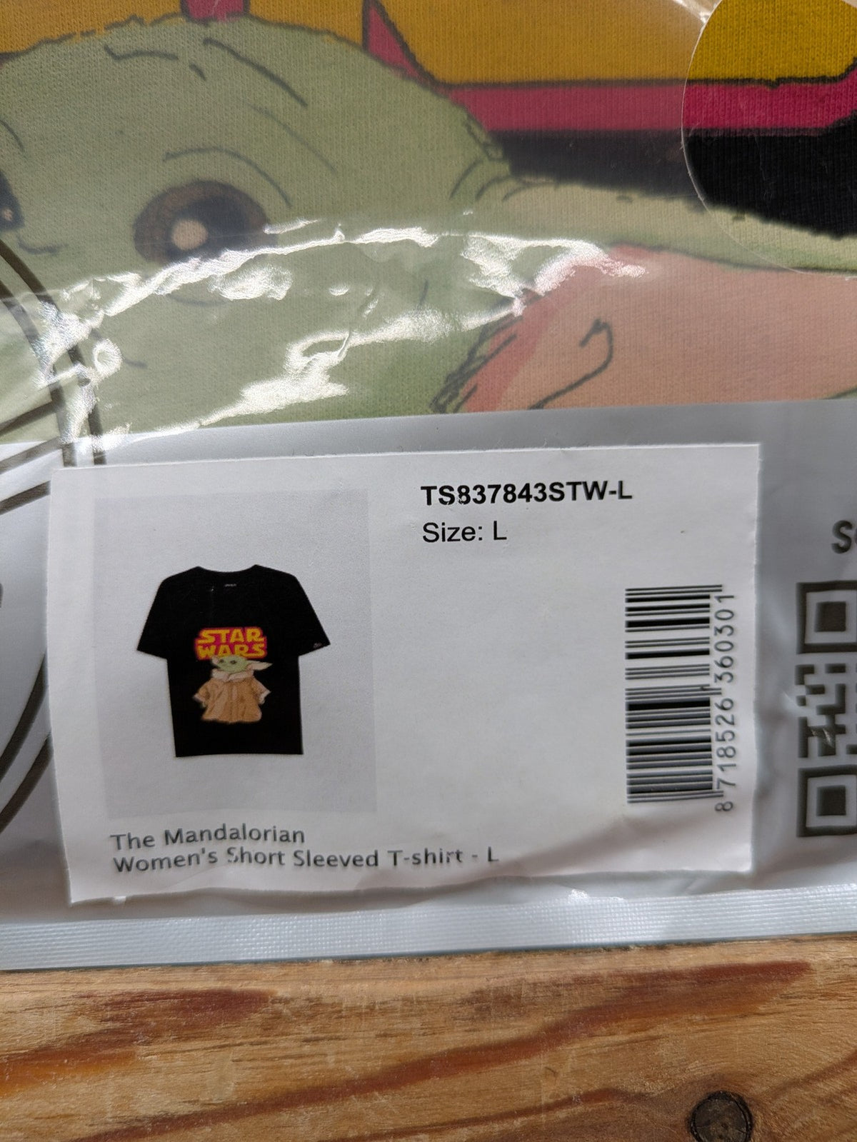 Star Wars black t-shirt featuring colorful Grogu graphic and short sleeves.