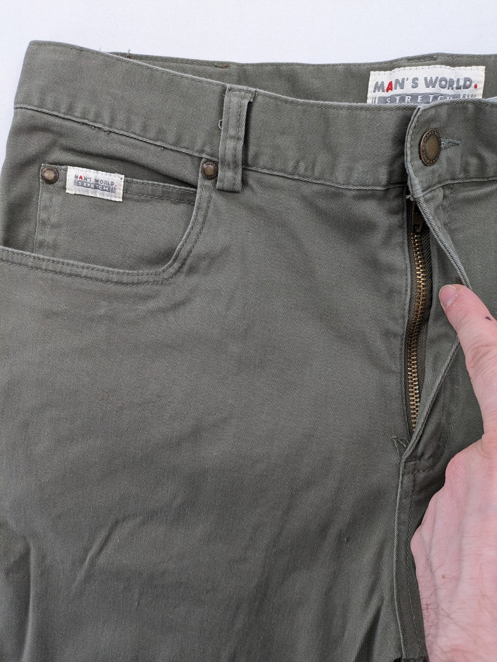 Man's World khaki chino pants with button and zipper closure, made from cotton-elastane blend.