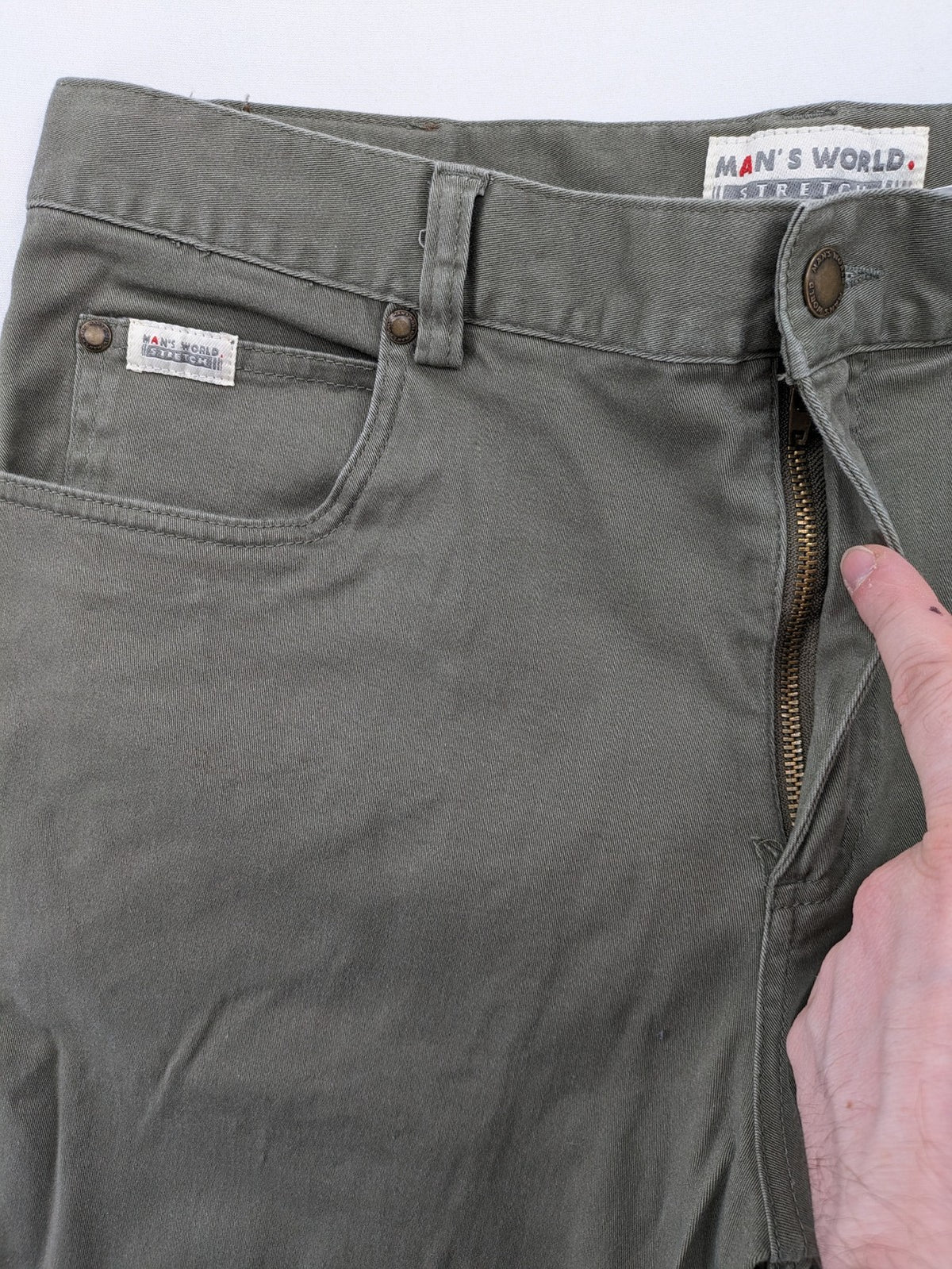 Man's World khaki chino pants with button and zipper closure, made from cotton-elastane blend.