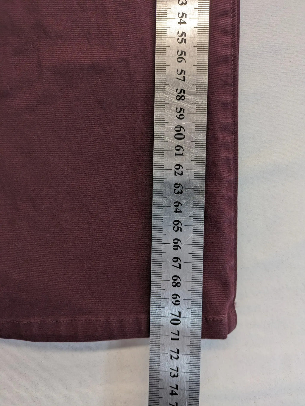 Kazane burgundy overalls with adjustable straps, side button placket, and chest pocket.