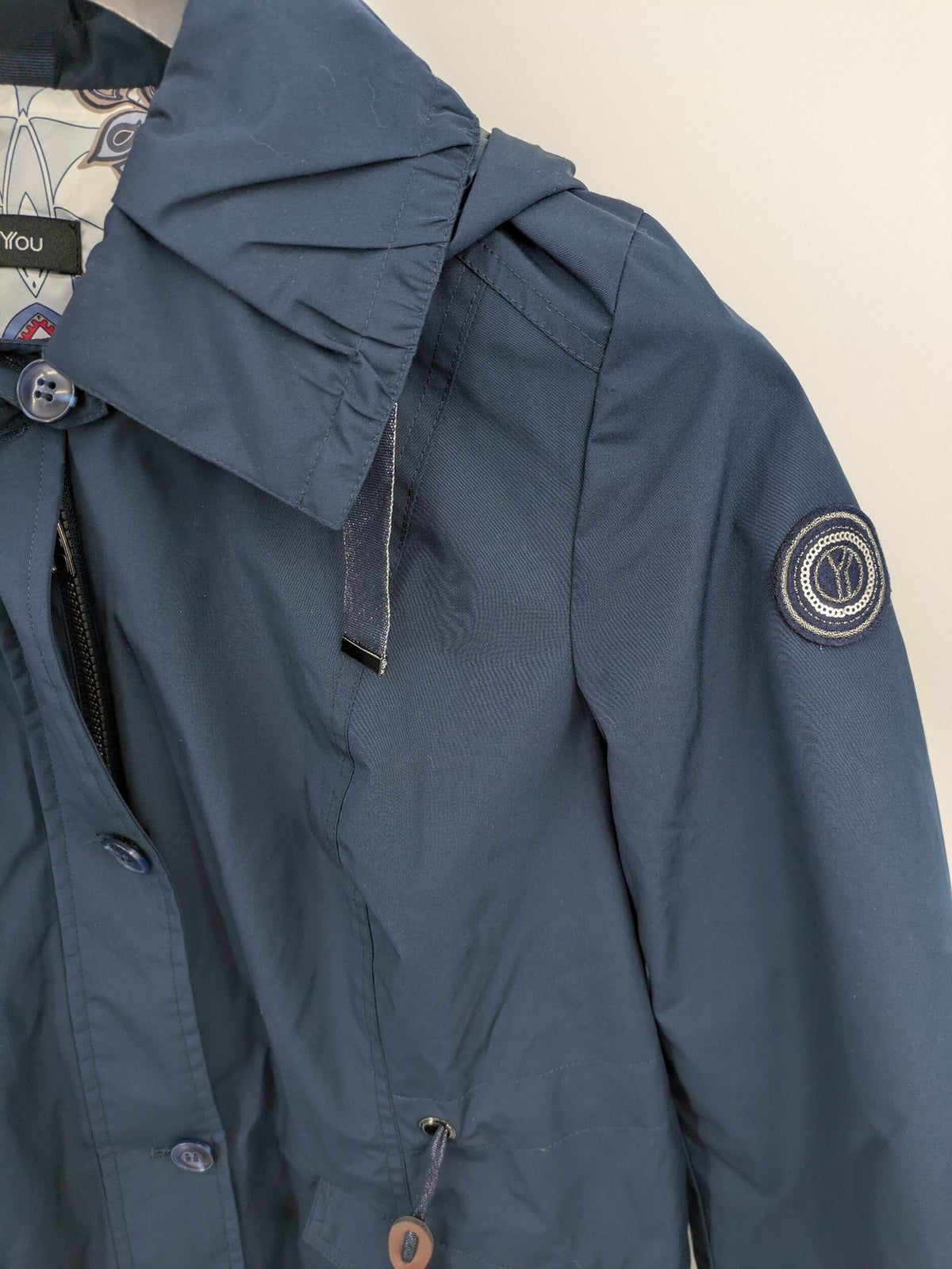 everYou navy parka jacket with hood, adjustable drawstring, patterned lining, button closure.