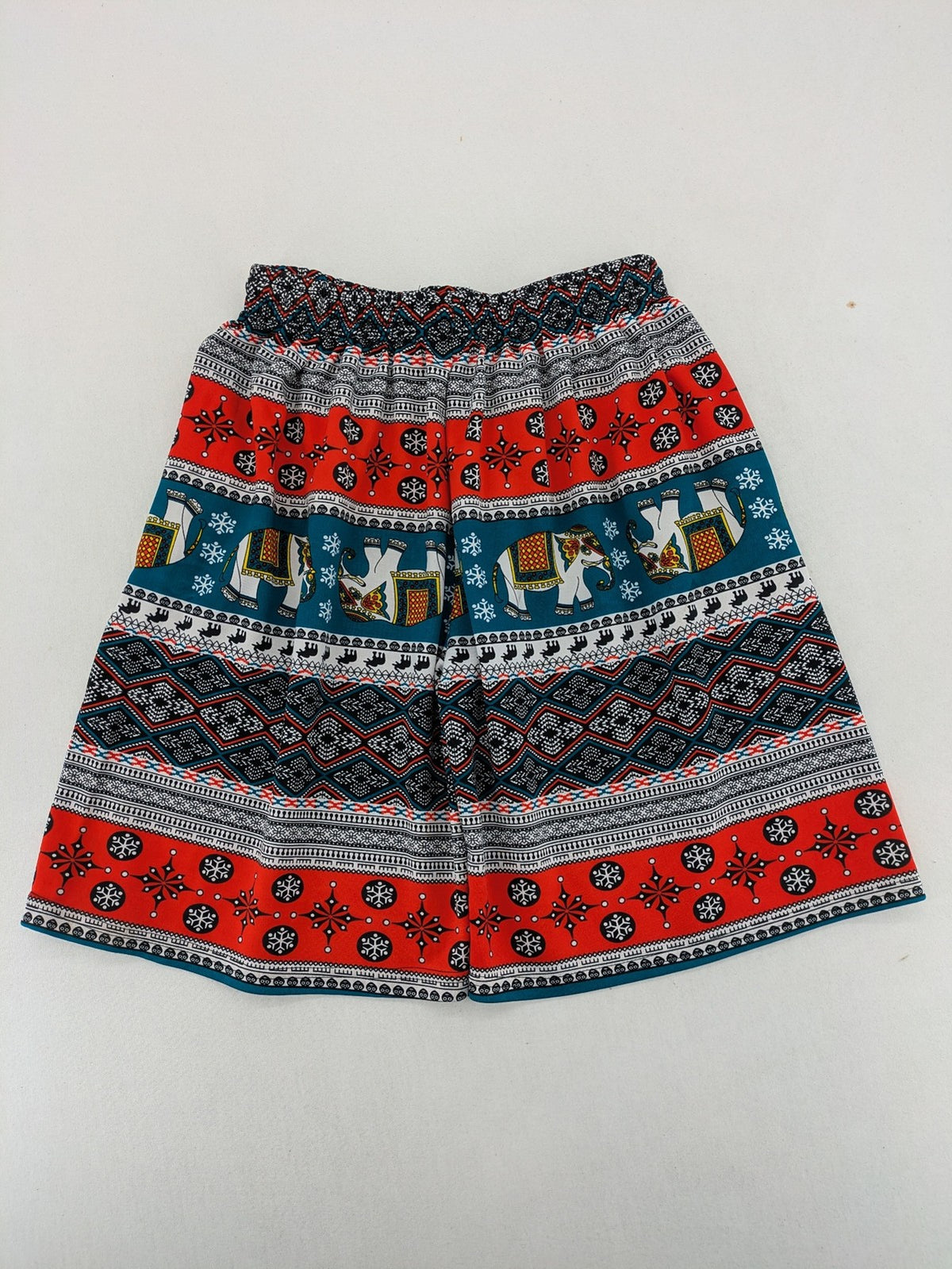 Elefanten multi shorts featuring vibrant elephant and geometric patterns with elastic waistband.