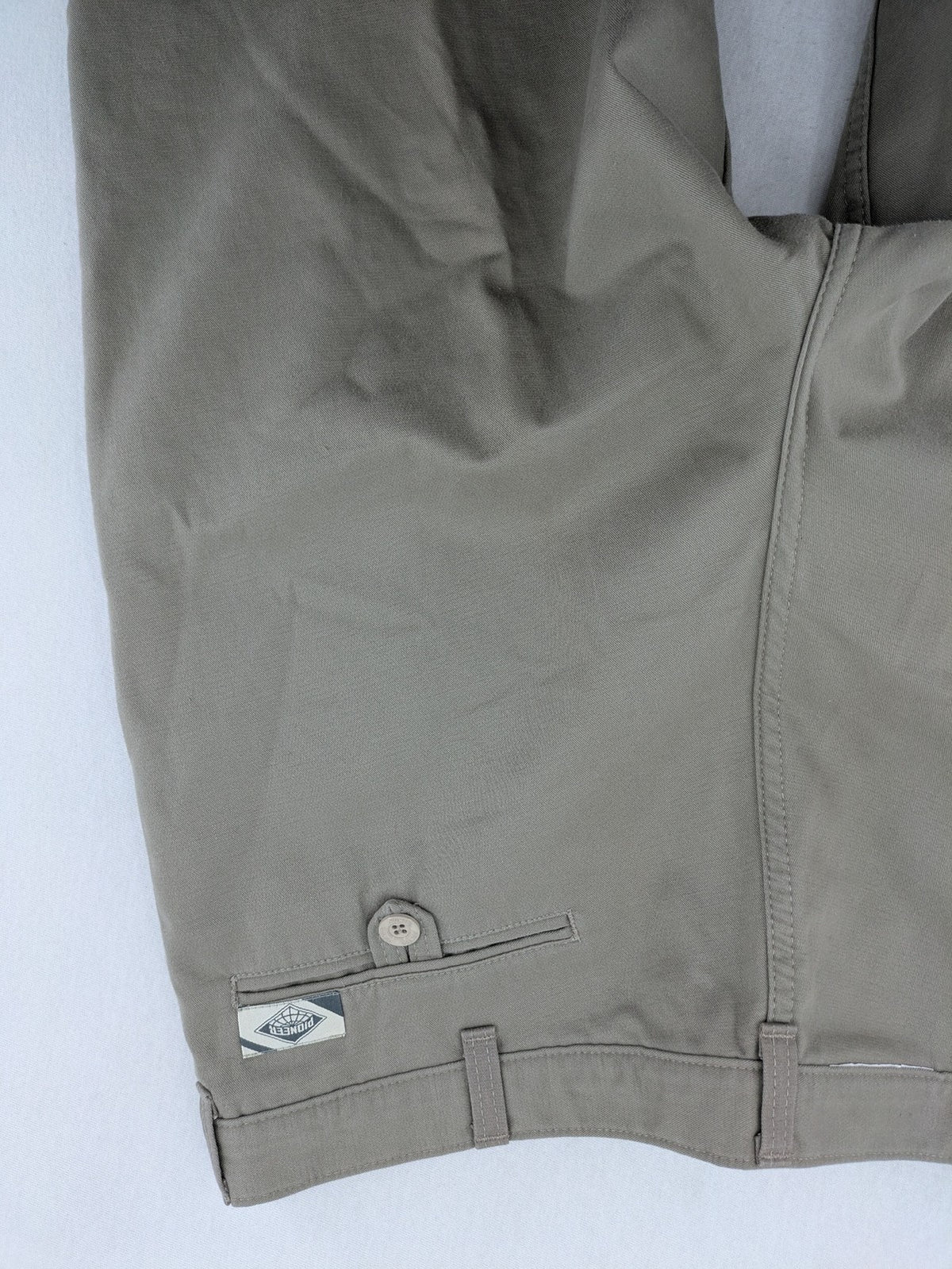 Pioneer beige chino trousers with pleats, straight leg, and buttoned back pocket.