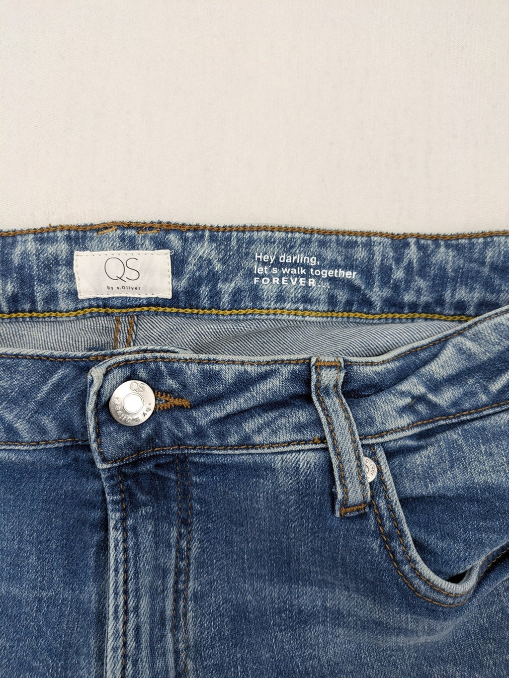 QS by s.Oliver green bootcut jeans with ankle zippers and classic denim wash.