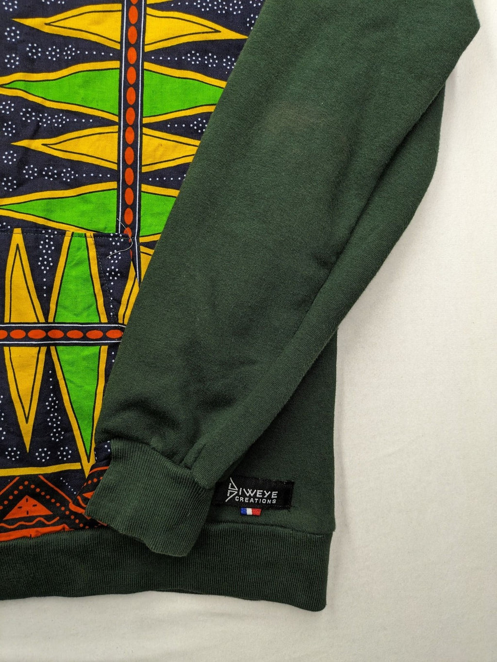 Diweye Creations multi turtle neck jumper with vibrant African print and soft green material.