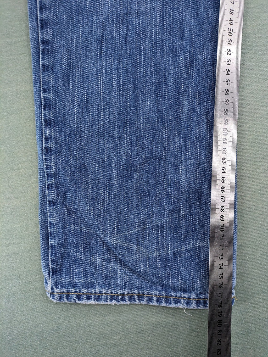 American Eagle Outfitters blue straight jeans with distressed detailing and classic five-pocket design.