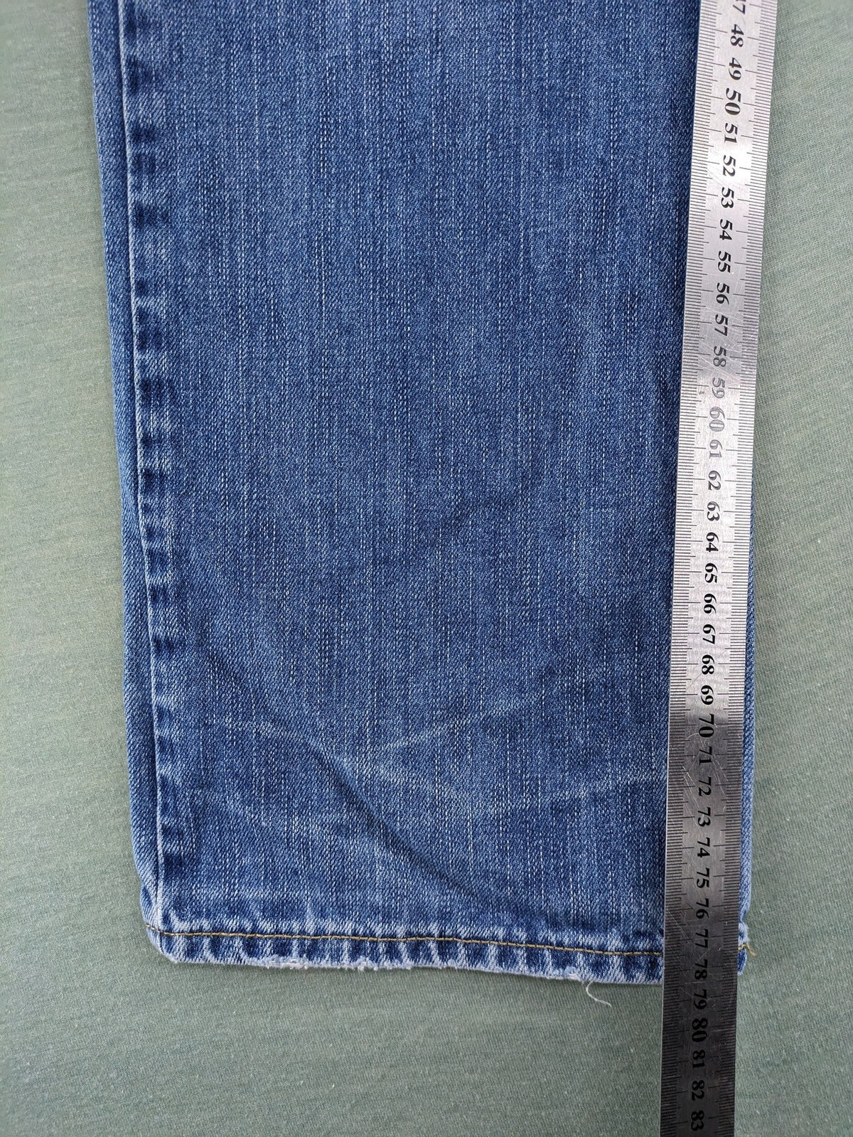 American Eagle Outfitters blue straight jeans with distressed detailing and classic five-pocket design.