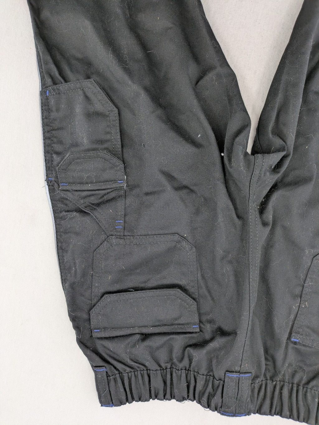 Powerfix Profi blue cargo pants with reflective stripes and side pockets, durable polyester-cotton blend.
