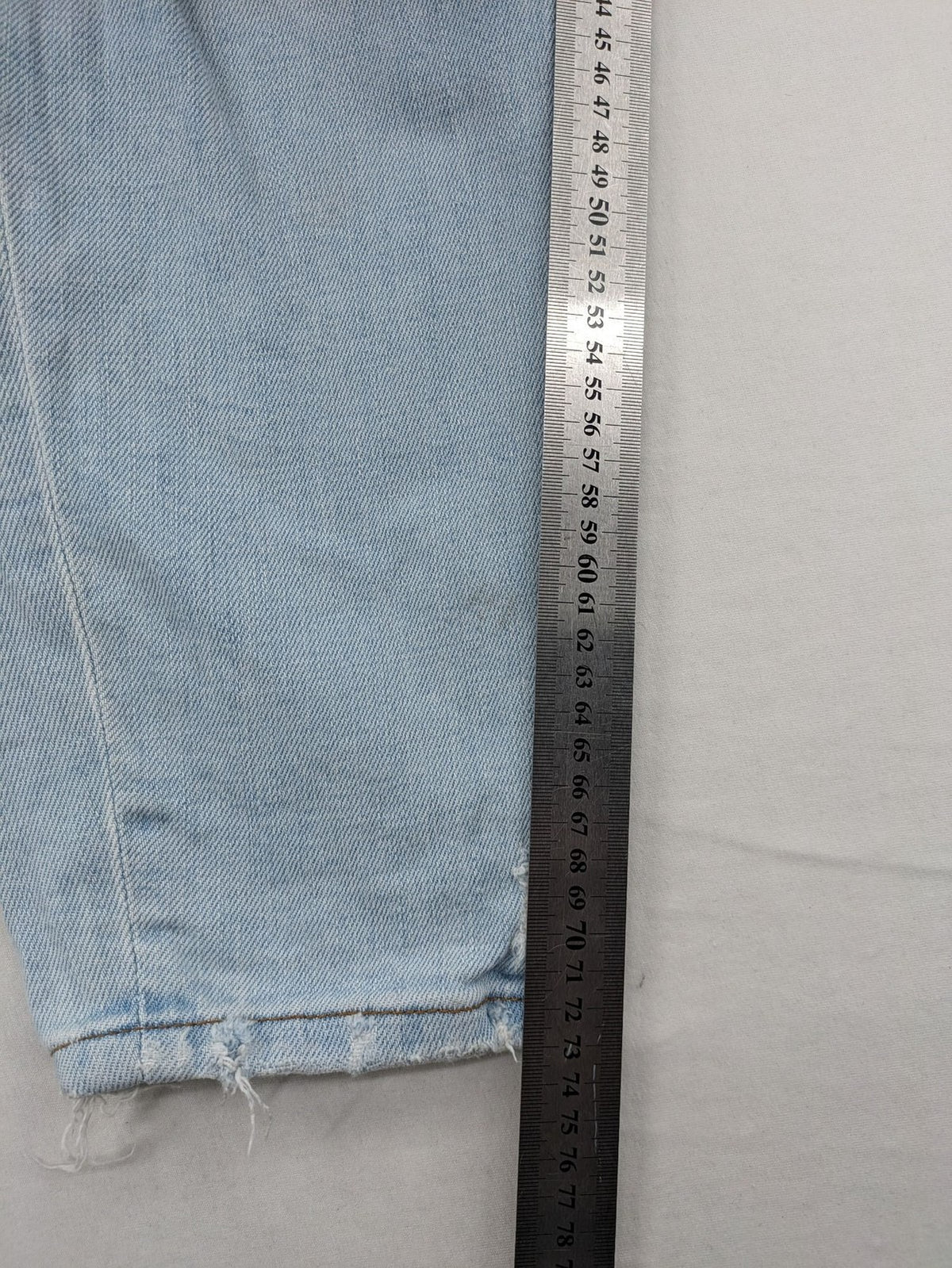 Zara blue straight jeans with distressed knees and classic button fly.