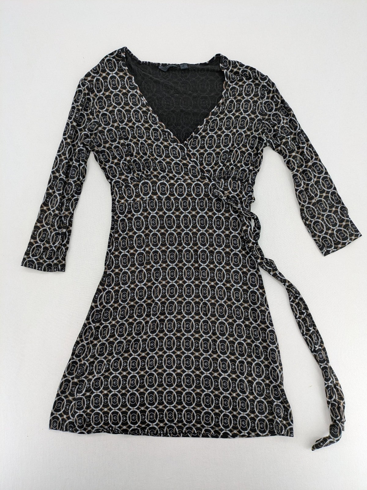TCM pink wrap dress with V-neck, 3/4 sleeves, geometric black, white, and brown pattern.