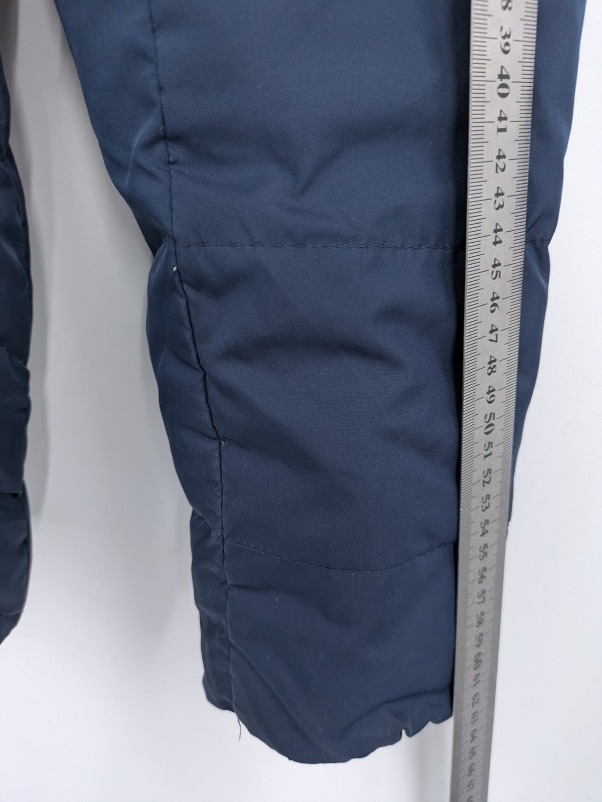 Esprit navy puffer jacket with belt, high collar, ribbed inner lining, and button placket.