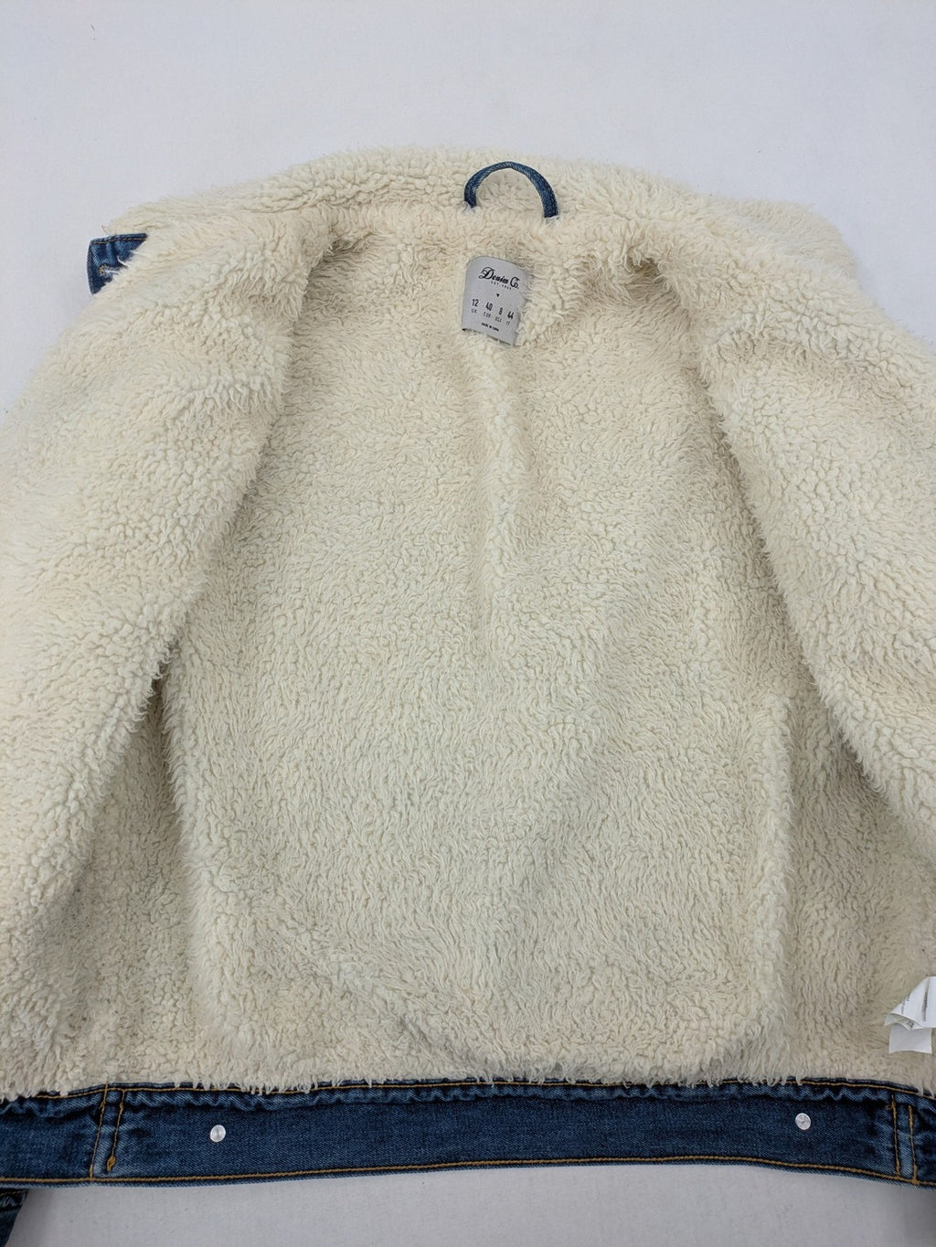 Denim & Co. blue jacket with cream Sherpa lining, button closure, and pockets.