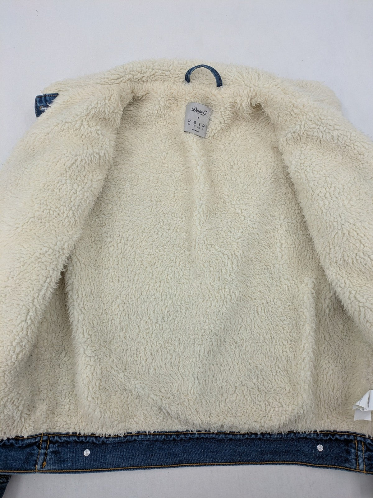 Denim & Co. blue jacket with cream Sherpa lining, button closure, and pockets.